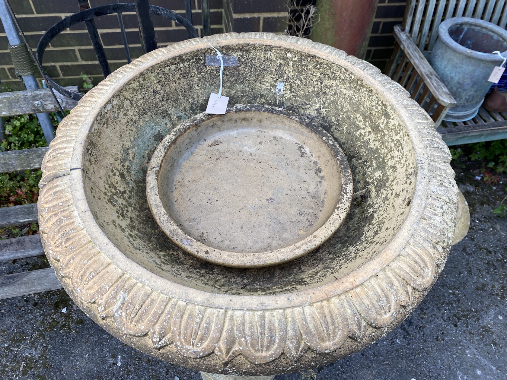 A circular stone planter on octagonal column, height 118cm